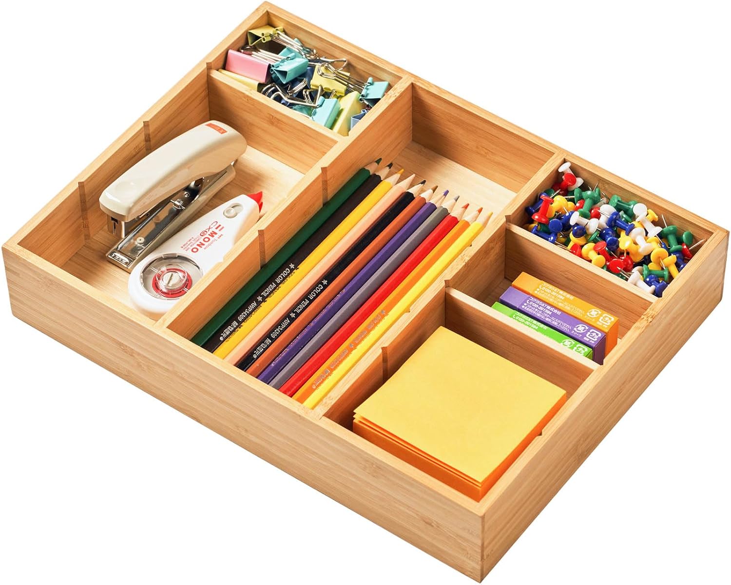 Bamboo desk drawer organizer tray holding pens, clips, and sticky notes