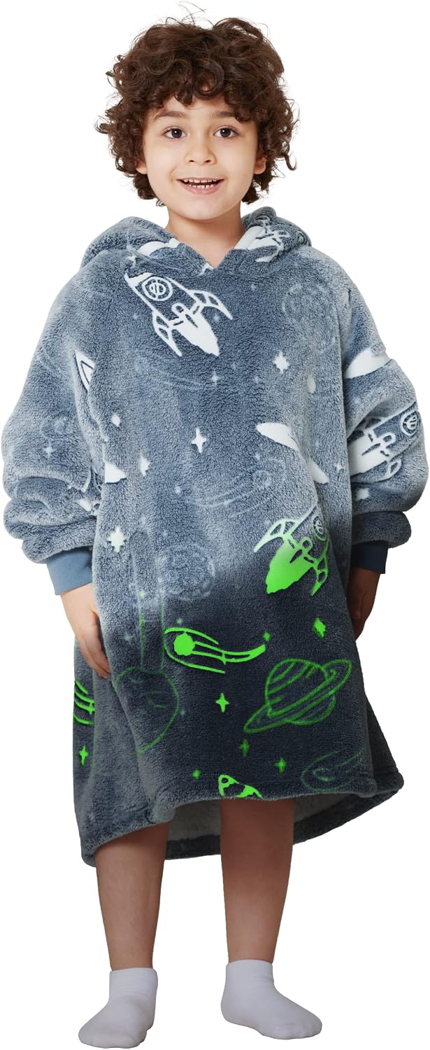 Tween boy wearing a Bedsure glow-in-the-dark sherpa blanket hoodie with spaceship print