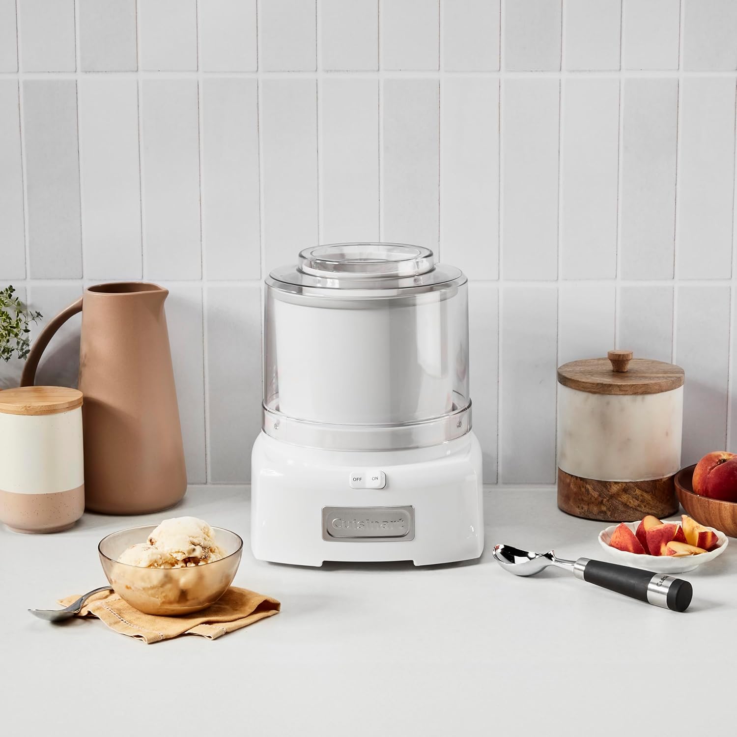 Cuisinart ice cream maker on a kitchen counter with a bowl of ice cream
