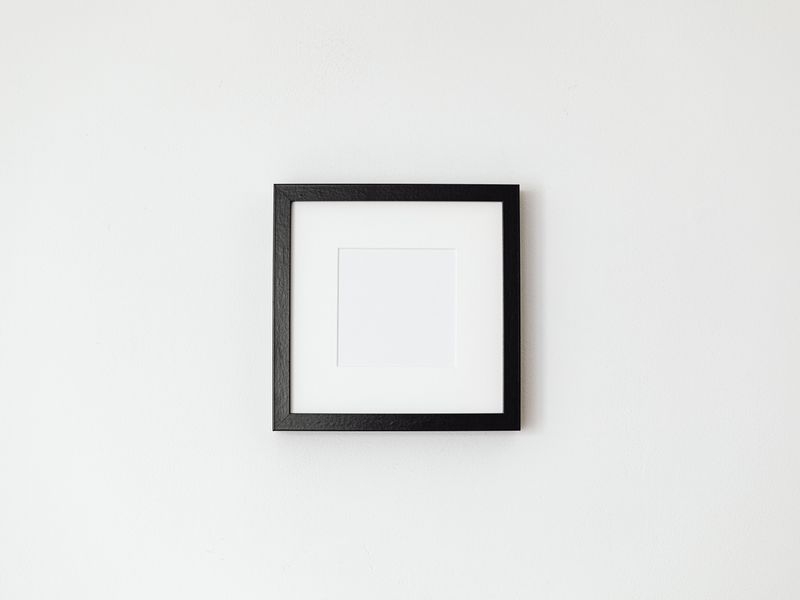 simple black picture frame on a white wall product photo