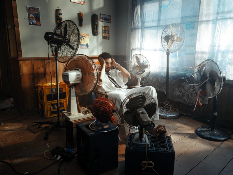 electric fans cooling a room on a sunny day