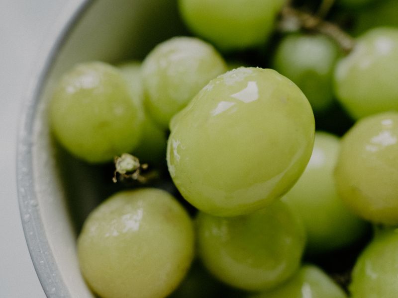 close-up bowl of frozen green grapes