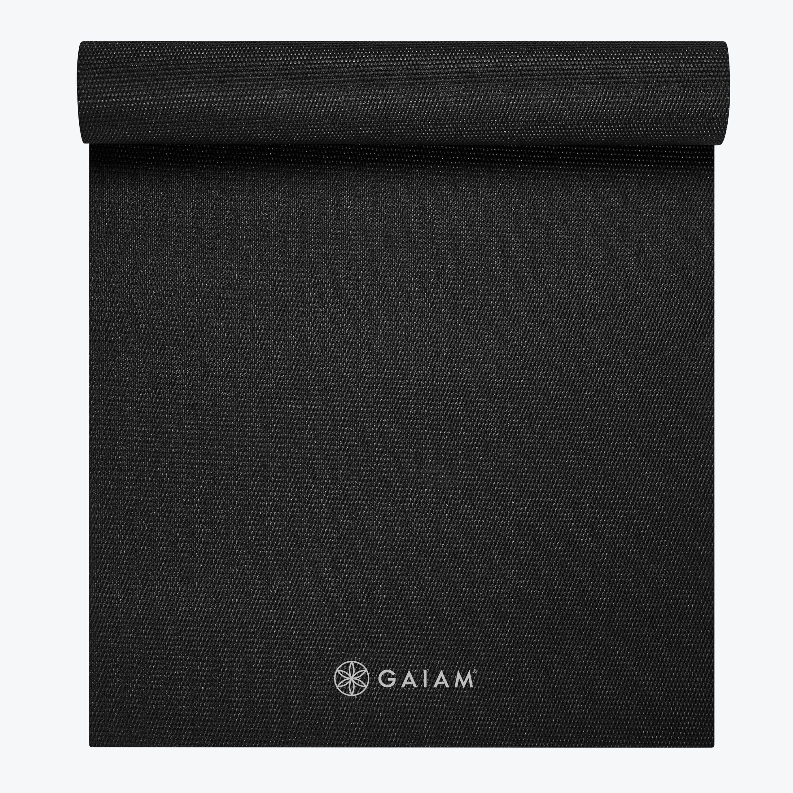 Gaiam Classic Solid Color Yoga Mat rolled up in black, real Gaiam branding visible