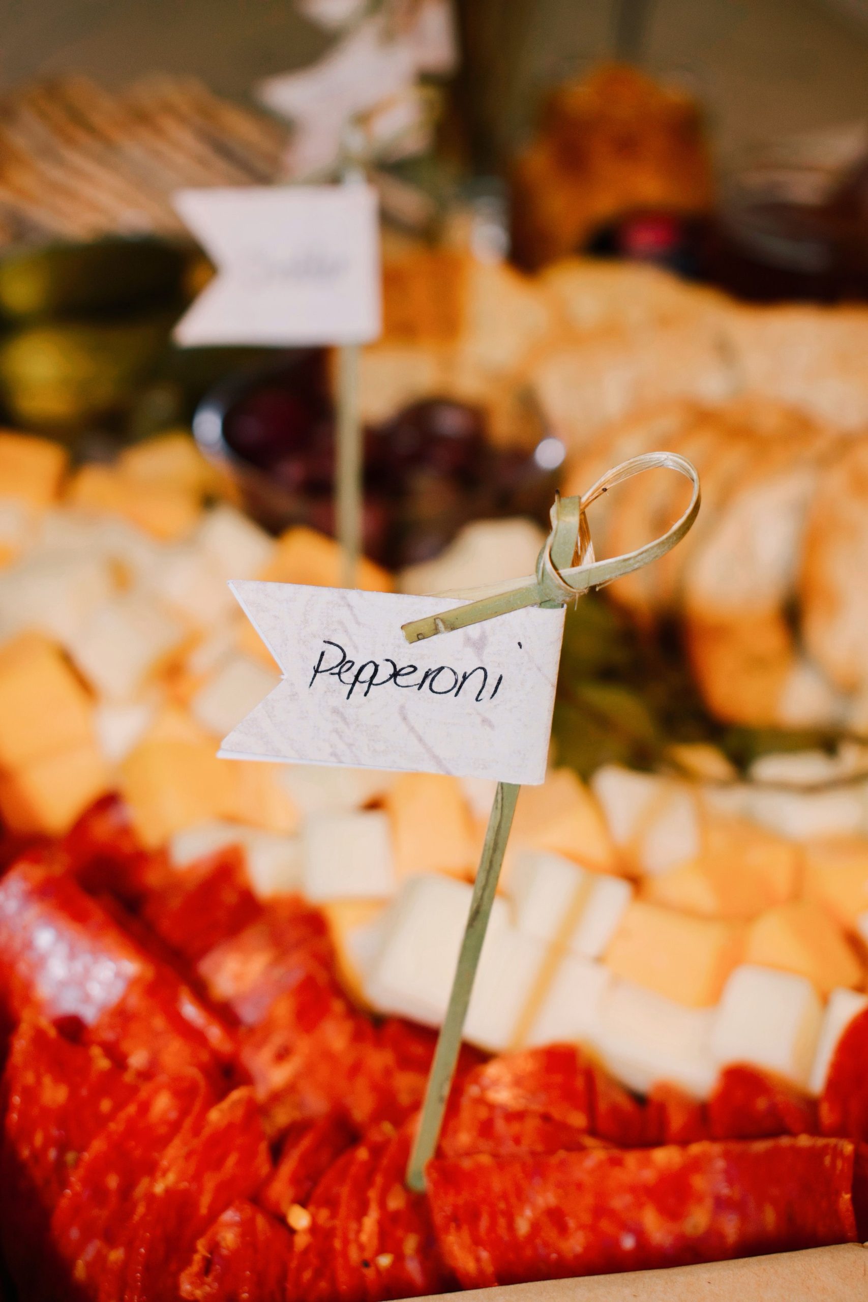 Cheese marker label on a stick in a charcuterie spread