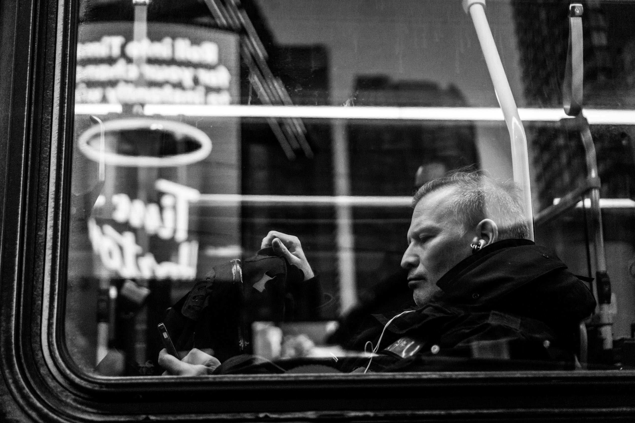 Man scrolling on his phone in grayscale, a visual metaphor for turning off color on your phone screen