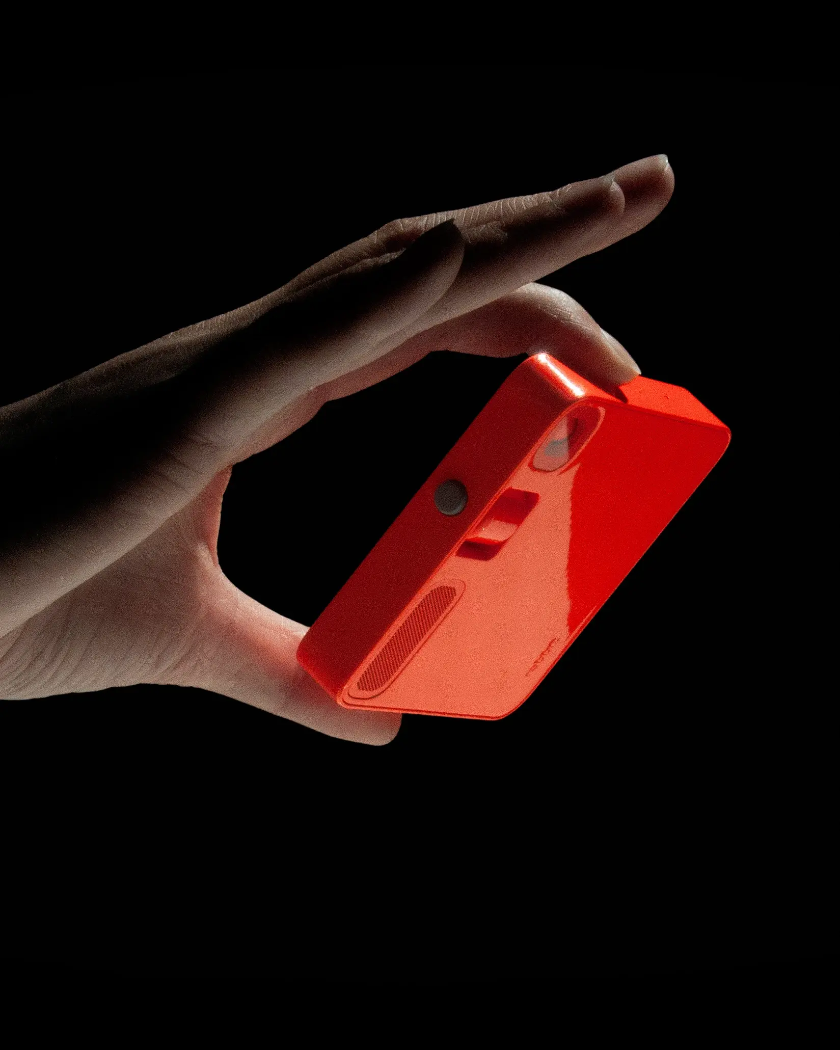 Rabbit R1 orange AI companion device held in hand