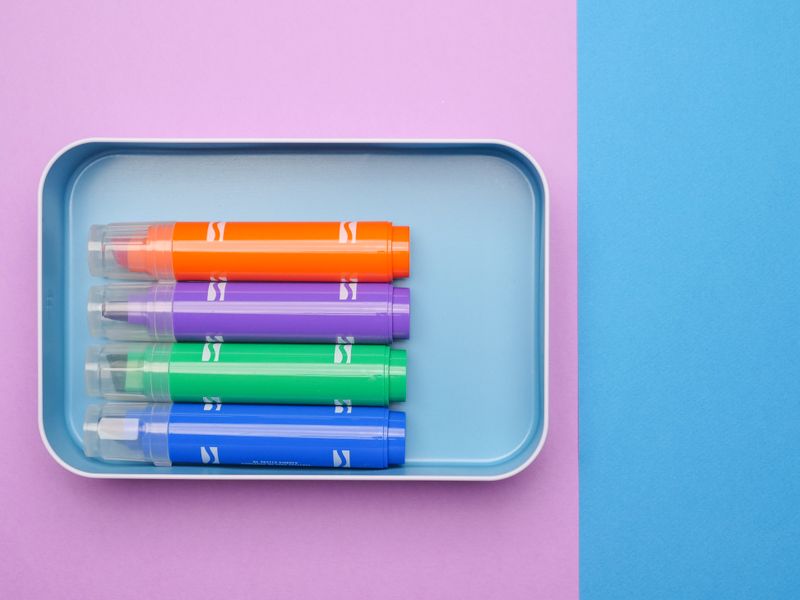 pastel highlighter markers in a tray product photo