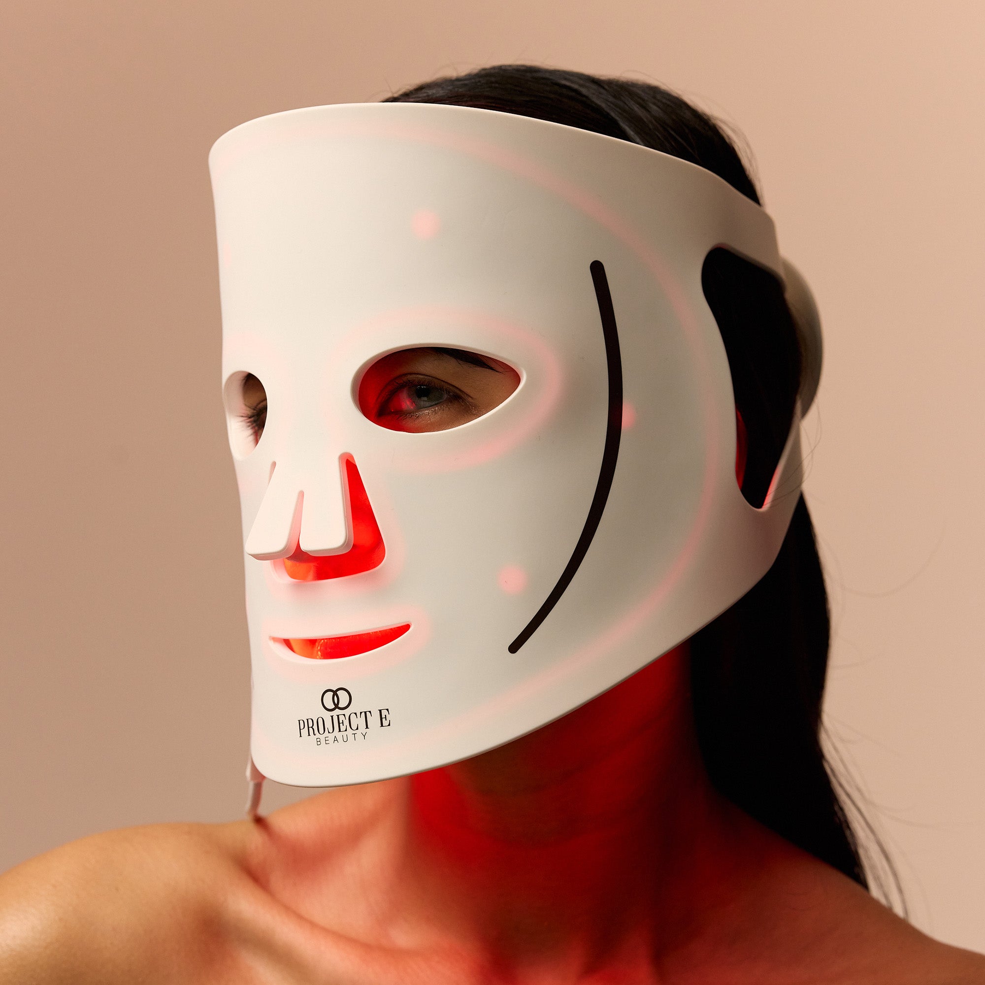 Project E Beauty LumaLux Face LED mask worn on face with visible red light therapy
