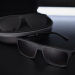 dark rectangular sunglasses resting near their case with dramatic tech lighting