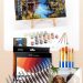 Collage of paint by numbers essentials including a framed finished canvas on an easel, acrylic paints, brushes, and a custom pet portrait kit