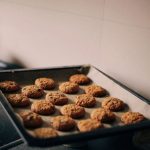 Freshly baked cookies on a baking sheet pan in a kitchen