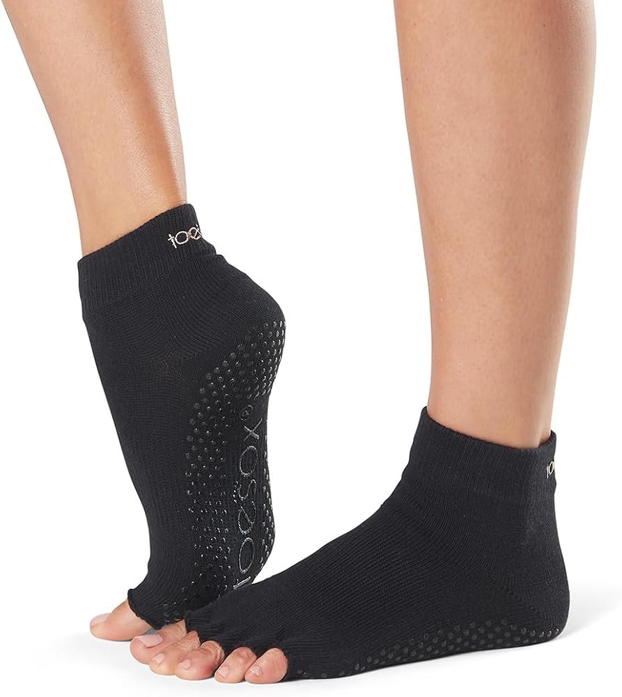 ToeSox grip pilates barre socks worn on feet showing non-slip sole grips
