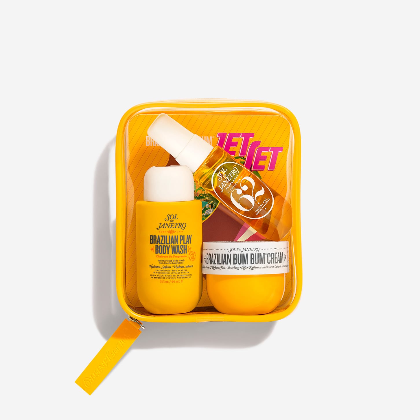 Sol de Janeiro Bum Bum Jet Set travel-size body wash, cream, and fragrance mist in a clear travel bag