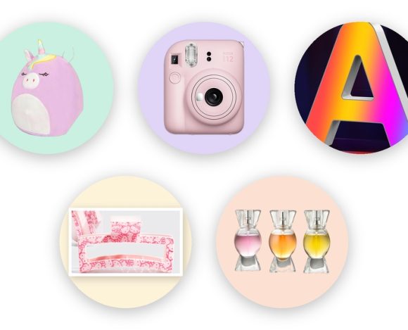 Tween girl gift ideas pastel circle grid: unicorn plush, pink instant camera, Hello Kitty claw clip, glowing marquee letter, and candy perfume trio